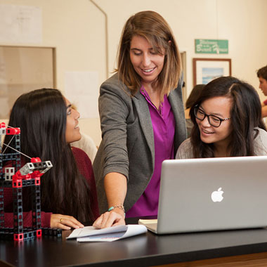 A teacher and 2 students using Rokenbok's SnapStack Module
